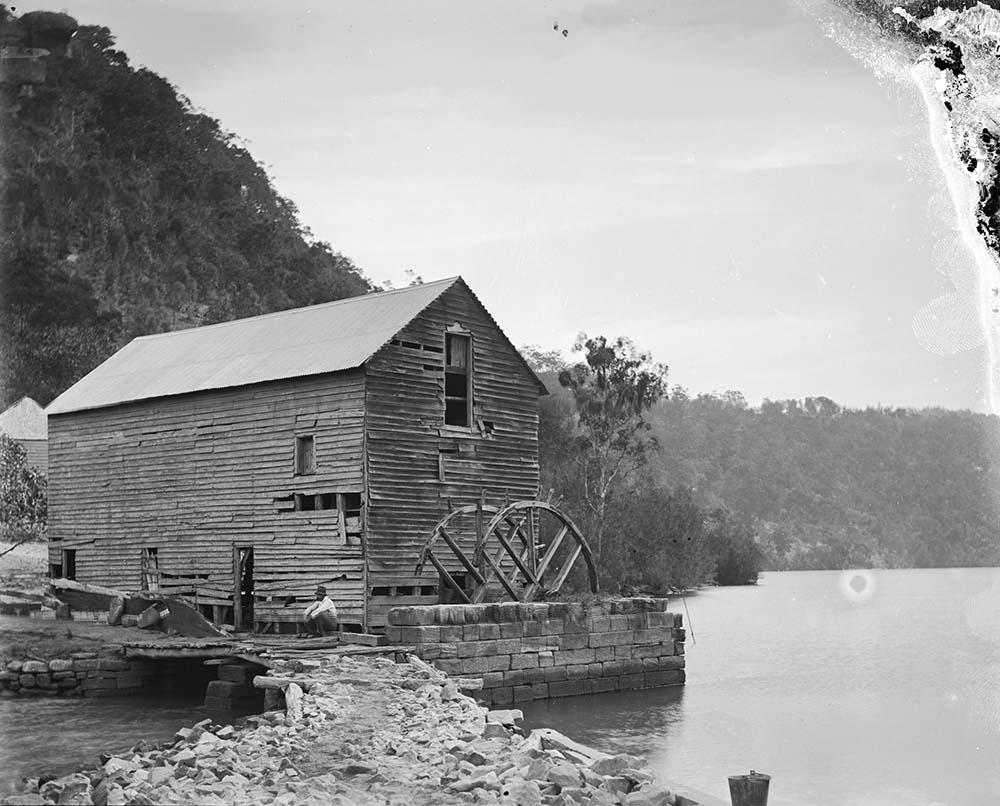A photograph by William Hall of Singletons flour mill and its old waterwheel at Layburys Creek, Wisemans Ferry NSW