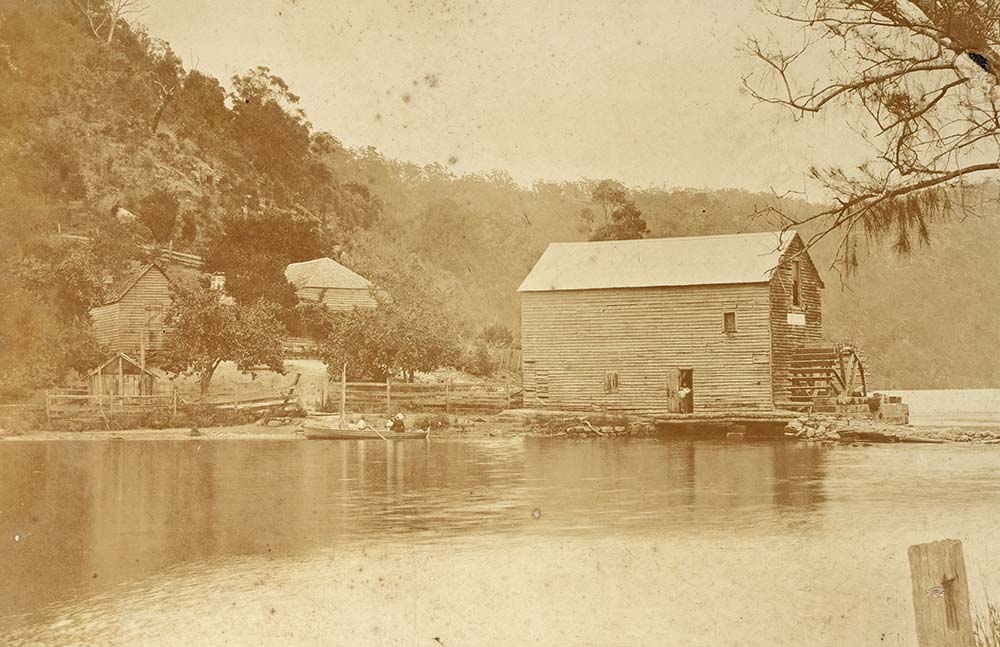 A photograph of Singletons Watermill at Layburys Creek, Wisemans Ferry showing the waterwheel and mill pond