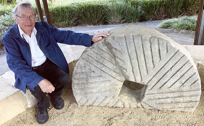 Les Dollin, researching the mills built by the Singleton Family - shown here with one of Benjamin Singleton's millstones from Kurrajong. sh